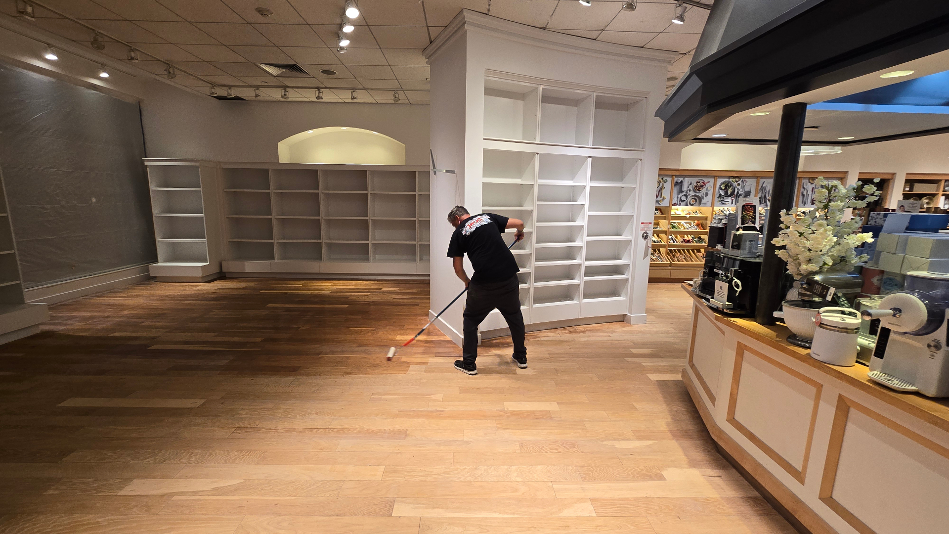 Michael Wheeler applying finish to a hardwood floor on the Manhattan Beach William Sanoma Project